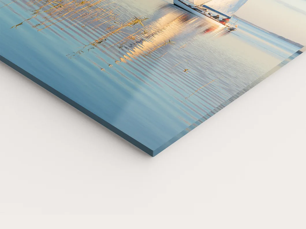 Close view of an acrylic print, the polished edge of the acrylic glass catching the light