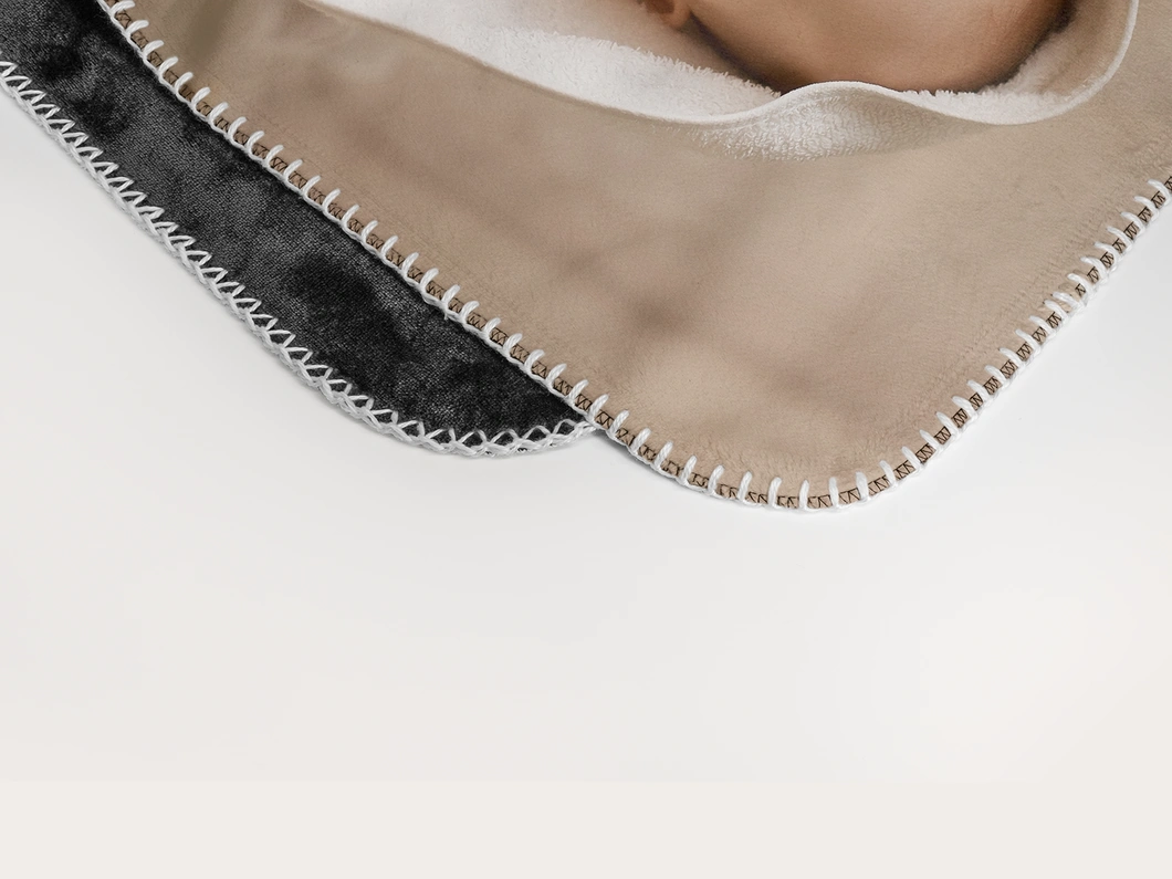 Close view of the blanket's stitched edge and plush back