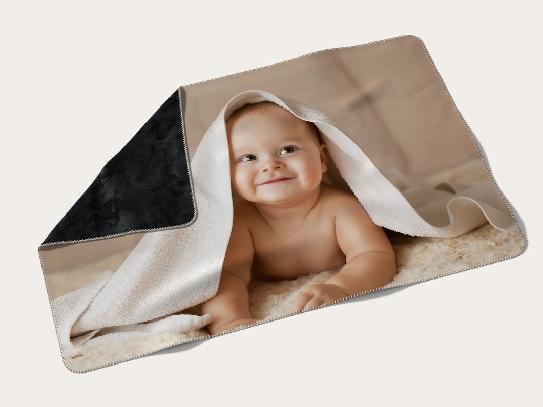 Premium plush photo blanket with a baby photo, one corner turned over to show the plush back