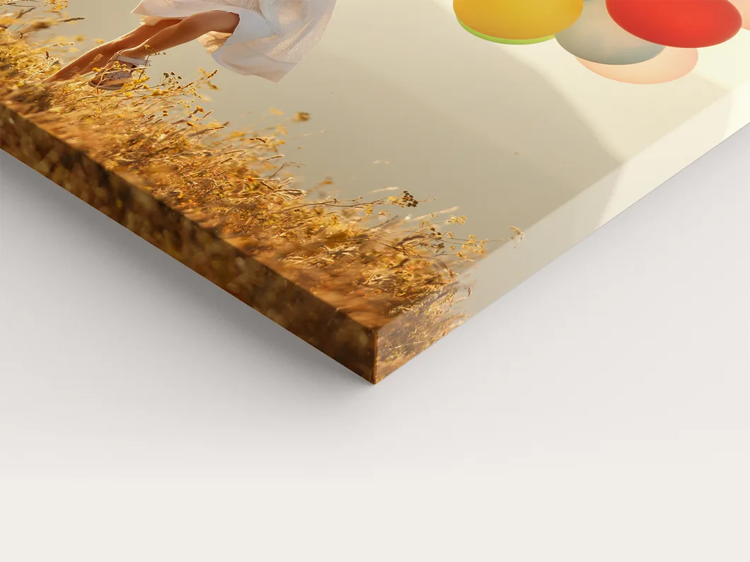 Close view of a canvas print corner, the photo wrapped over the edge of the stretcher frame