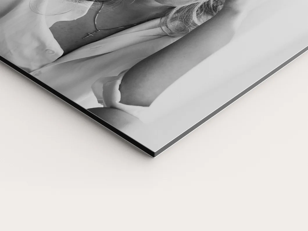 Close view of a metal print corner showing the thin composite panel