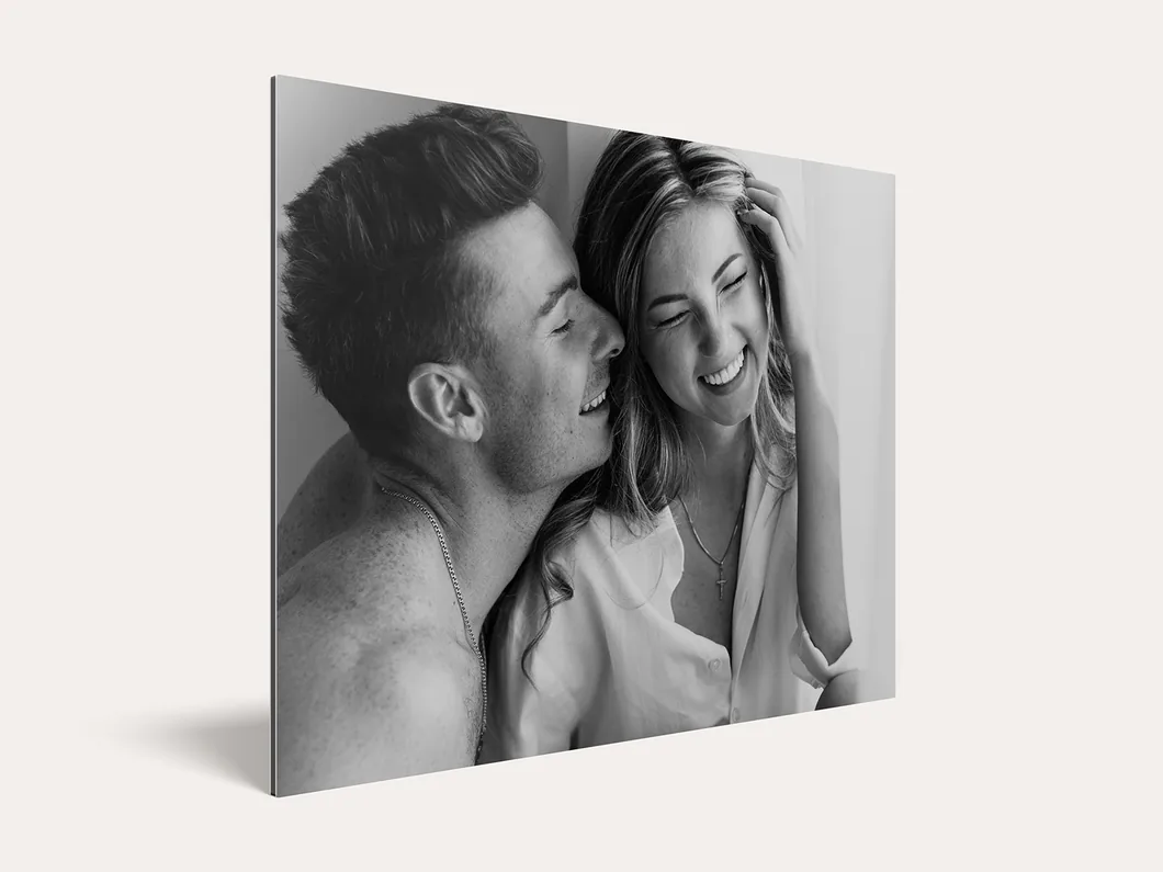 Metal photo print of a black-and-white portrait of a couple, seen at an angle