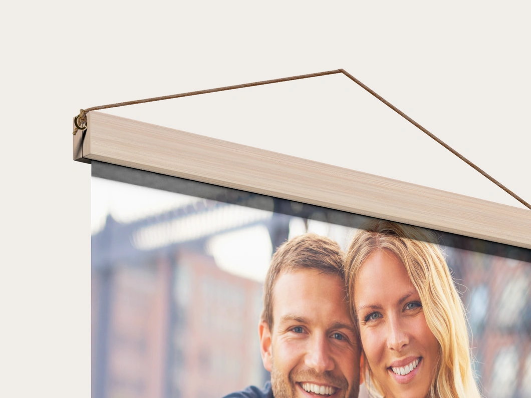 Close view of the wooden rail and hanging cord on a canvas wall hanging