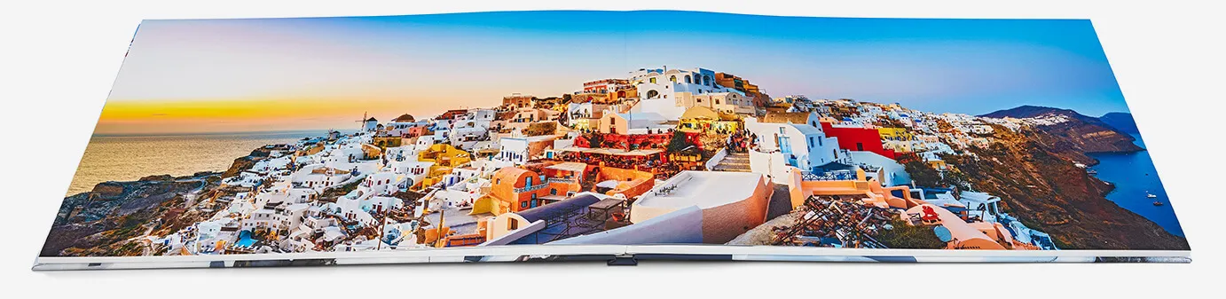 An 8x11 hardcover real photo paper book opened completely flat, with a photograph crossing both pages