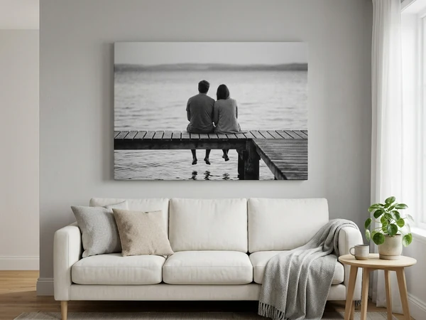 A black and white photo canvas hung centrally above a sofa in a living room