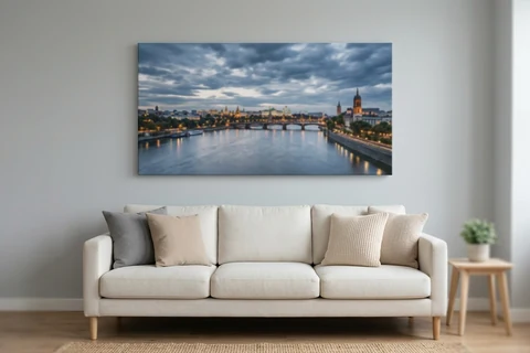 A panoramic city skyline printed on a wide canvas and hung above a sofa